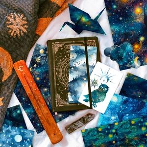 Detail of starry sky scrapbooking set with navy notebook and astronomical stickers
