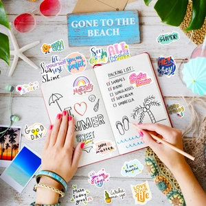 Vibrant waterproof vinyl stickers with inspirational quotes on an open journal