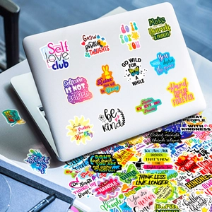 Close-up of colorful waterproof inspirational stickers decorated on a silver laptop case