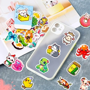 Close-up of waterproof cute animal graffiti stickers on phone case and paper surfaces