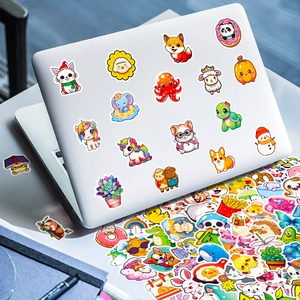 Macro shot of cute cartoon animal stickers applied to a silver laptop cover