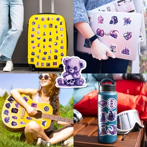 Purple gothic stickers applied on yellow suitcase, laptop and guitar for decoration