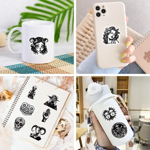 Gothic black and white stickers shown on a mug, phone case, laptop and water bottle