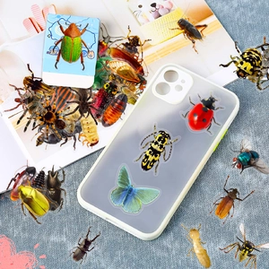 Detail of 3D realistic insect stickers showing butterfly and beetle on phone case