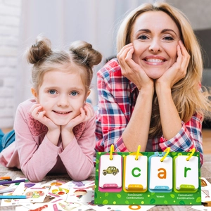 Close-up of a mother and daughter using the educational phonics flipbook with word cards