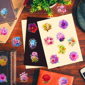 Close-up of colorful laser-cut floral PET stickers on vintage wooden desk and book
