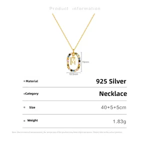 Detail of 925 sterling silver necklace with M initial pendant and colorful crystals