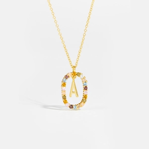 Close-up of gold 925 silver necklace with letter A and multi-colored cubic zirconia stones