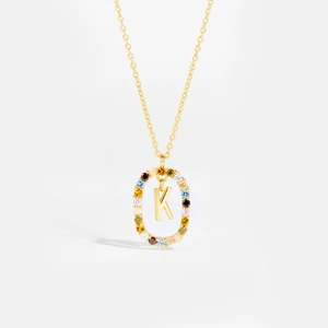 Detailed macro view of 925 silver gold necklace with colorful zircon K initial pendant