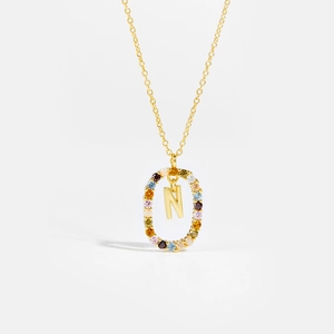 Macro shot of 925 silver necklace with letter N pendant and colorful zircon stones