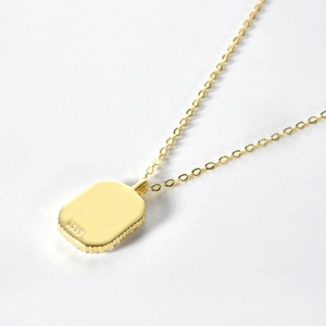Macro shot of S925 sterling silver stamp on the back of gold-plated zodiac pendant