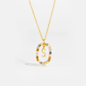 Close-up of golden letter S necklace with multi-color zircon stones and fine chain