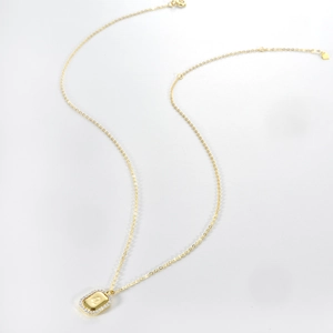 Close-up of gold necklace featuring a rectangular L-letter pendant with zircon border