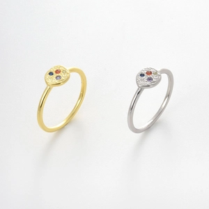 Detail of minimalist S925 silver rings with colorful zircon and hammered metal texture