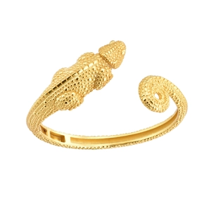 Macro detail of golden lizard wrap ring showing textured lizard skin and spiral tail