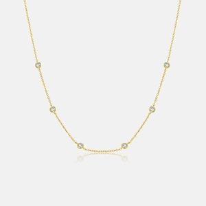 Detail of elegant gold choker necklace with six round bezel-set sparkling cubic zirconia