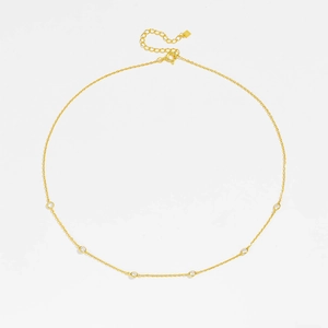 Detail of adjustable gold lobster clasp and sparkling zircons on the fine link chain