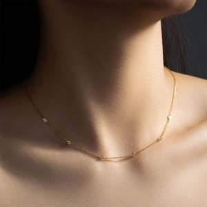 Elegant gold plated S925 silver necklace with six sparkling round zircons on model neck