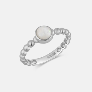 Macro shot of S925 sterling silver ring featuring bead texture and white opal stone