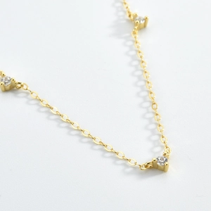 Macro view of a gold-plated S925 silver chain necklace with inlaid round zircons