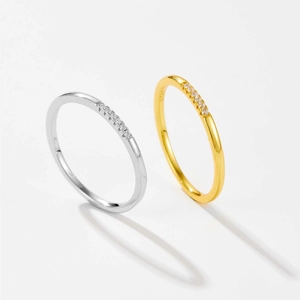 Detailed macro view of S925 sterling silver and gold slim rings with pavé cubic zirconia