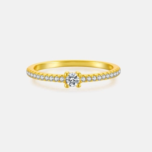 Macro view of gold S925 silver ring with circular cubic zirconia paved in four-prong setting