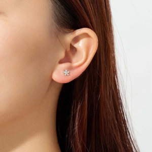 Minimalist S925 sterling silver flower stud earrings with center zircon on a model