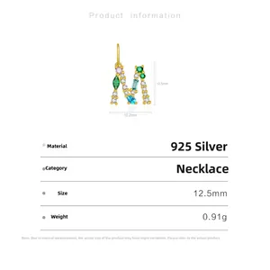 Macro detail of silver M pendant with multi-color stones and dimensions measurement