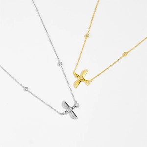 Macro detail of 925 sterling silver swallow pendant necklace with shimmering pave diamonds