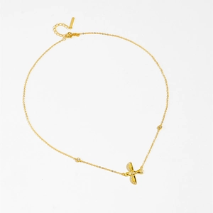 Macro detail of bird pendant with sparkling zircons on a gold S925 silver chain