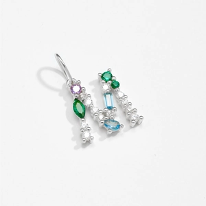 Detailed view of sterling silver letter M pendant with colorful gemstones and zircon pavé