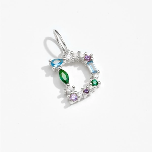 Close-up of 925 silver D letter pendant featuring colorful gemstone inlay details