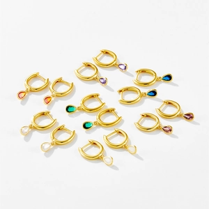 Macro shot of 7 pairs of S925 silver hoop earrings with colorful pear-cut zircon drops