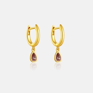 Macro detail of S925 silver drop earrings featuring pear-cut zircon and golden finish