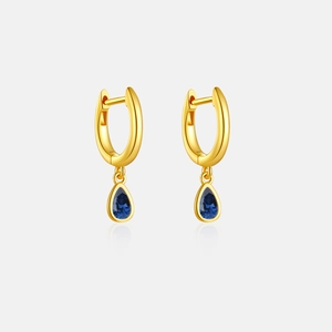 Detail of gold-plated S925 silver earrings with pear-cut blue zircon stone pendants