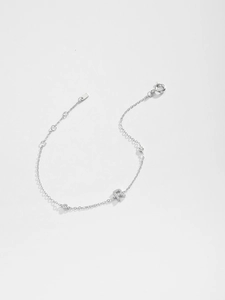 Macro detail of S925 sterling silver chain bracelet with zircon-encrusted letter R charm
