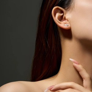 Elegant S925 sterling silver wing earrings with micro-set zircons on a female model