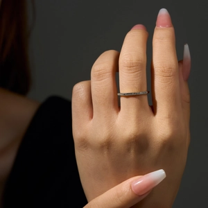 Close-up of minimalist S925 sterling silver thin ring with sparkling row of cubic zirconia