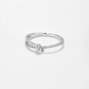 Macro shot of S925 sterling silver knot ring featuring sparkling pave zircon setting