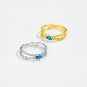 Detailed macro view of S925 sterling silver dual-layer rings with pear-cut blue zircon