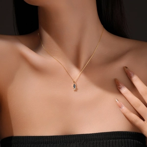 Minimalist S925 silver gold-plated necklace with marquise blue stone on elegant model