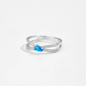 Detailed macro shot of an S925 silver ring featuring a teardrop-shaped blue gemstone
