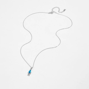 Macro view of S925 sterling silver chain with marquise blue gemstone and white zircon detail