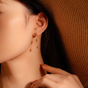 Elegant gold daisy earrings for women featuring delicate flower petals and dangling chains