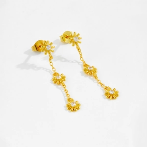 Detailed macro of gold S925 silver daisy dangle earrings with sparkling zircon stones