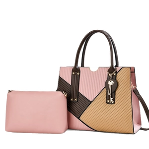 Two-piece set of patchwork tote and pink clutch bag in elegant urban commuter style