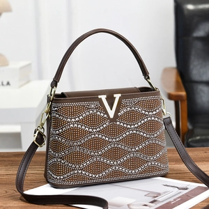 Brown striped handbag with rhinestone V design and adjustable shoulder strap
