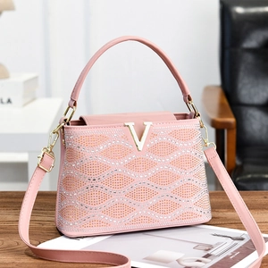 Pink striped handbag with sparkling rhinestones and golden V-shaped buckle design
