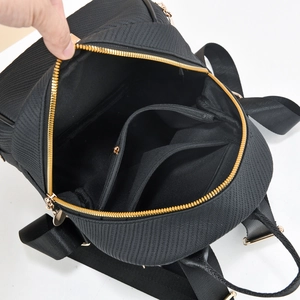 Innendetails eines schwarzen karierten Rucksacks mit drei Fächern und Goldzipper