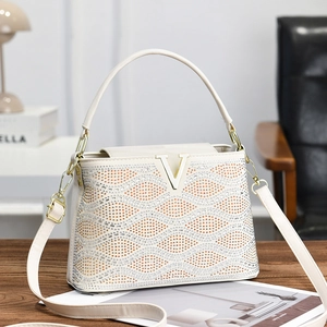 Chic cream striped tote bag with sparkling rhinestones and golden V-shaped buckle